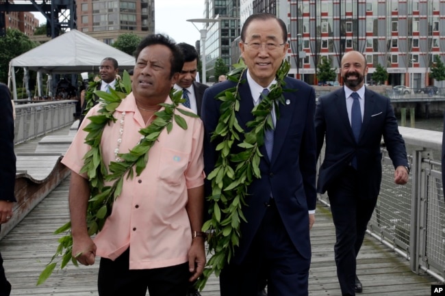 FILE - Palau President Tommy Remengesau (left) and United Nations Secretary General Ban Ki-moon (center) arrive for ceremonies for the observance of World Oceans Day, in New York, June 8, 2016.