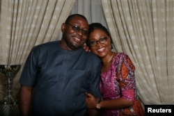 Oladipupo Baruwa, 45, an investment promotion officer, and Funke Baruwa, 43, a gender and development expert, pose for a photograph at home in Abuja, Nigeria, Feb. 9, 2018.