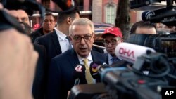 FILE - Turkish Ambassador Serdar Kilic, center, speaks to reporters and supporters near the White House in Washington, May 15, 2017. 