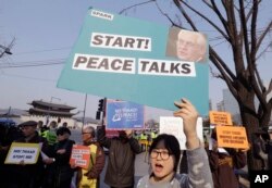 FILE - South Korean protesters stage a rally opposing a visit of U.S. Secretary of State Rex Tillerson as they wait for his arrival in front of the government complex in Seoul, March 17, 2017