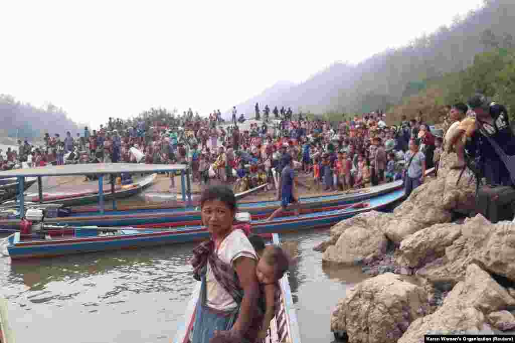 Karen refugees carrying belongings are seen at Salween riverbank in Mae Hong Son, Thailand.