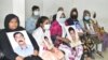 Members of families of enforced disappearances with the photos of the disappeared victims at a press briefing in Dhaka on January 15, 2022. At the press briefing, the families alleged that they are being hounded by the security agencies. (Photo, Badal Das)