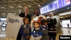 FILE - U.S Ambassador to Jordan Alice Wells,poses with the family of Syrian refugee Ahmad al Aboud, at the Queen Alia International Airport in Amman, Jordan, April 6, 2016. The family was headed for resettlement in the United States.