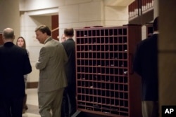 Members of Congress stow their cellphones and electronic devices before entering a closed-door intelligence briefing on Capitol Hill, Jan. 13, 2017.