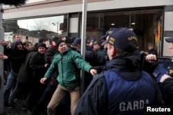 Members of the Garda Public Order Unit and riot police confront protesters at an anti-racism demonstration against the launch of an Irish branch of Pegida in Dublin, Ireland, Feb. 6, 2016.