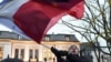 FILE - A protester waves the flags of Poland and the European Union in front of the Polish Constitutional Court in Warsaw on Dec. 3, 2015. The Polish parliament's lower house on Sept. 13, 2024, approved legislation to reform the court.