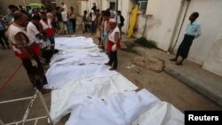 Bodies of people killed by an airstrike on a fish market are laid out in plastic bags at a hospital in Hodeida, Yemen, Aug. 2, 2018.