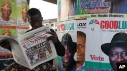 A man reads a local newspaper in Lagos, April 3, 2011