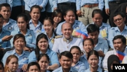 File - Lawmaker Hun Many, who heads the CPP-affiliated youth group -- Union of Youth Federation of Cambodia (UYFC), poses for group photographs with members of the UYFC at the Independence Day celebration in Phnom Penh on November 9, 2015.