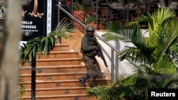 A Kenyan soldier walks out of the main gate of Westgate Shopping Center in Nairobi Sep. 22, 2013.