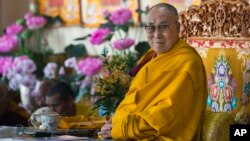 Tibetan spiritual leader the Dalai Lama sits on his ceremonial chair as he presides over the inauguration of the Namgyal Monastery School in Dharmsala, India, Nov. 2, 2017.