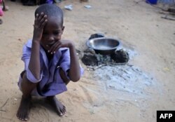 FILE - A displaced Somali child sits at a makeshift camp in the Garasbaley area on the outskirts of the capital Mogadishu, May 24, 2017.