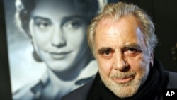 FILE - Maximilian Schell poses in front of a poster of his sister Maria Schell in Frankfurt, Germany, Jan. 30, 2007.