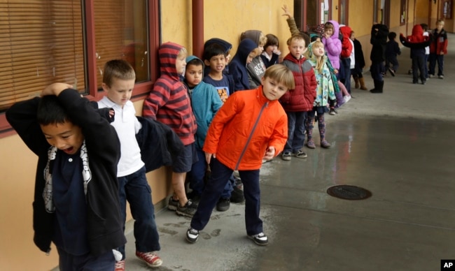FILE-- A first grade class of 30 children waits to enter a classroom, Jan. 24, 2013, at the Willow Glenn Elementary School in San Jose, California. (AP Photo/Ben Margot)