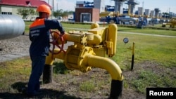 FILE - A worker turns a valve at an underground gas storage facility near Striy, Ukraine, May 21, 2014.