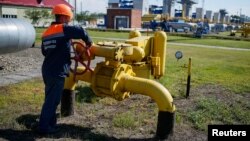 FILE - A worker turns a valve at an underground gas storage facility near Striy, Ukraine, May 21, 2014.