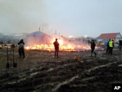 Dakota Access pipeline opponents burn structures in their main protest camp in southern North Dakota near Cannon Ball, N.D., Feb. 22, 2017, as authorities prepare to shut down the camp in advance of spring flooding season.
