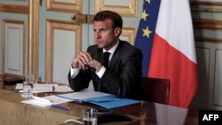 FILE - French President Emmanuel Macron is seen during a video conference at the Elysee Palace in Paris, May 18, 2020.