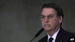 Brazil's President Jair Bolsonaro speaks at Planalto presidential palace in Brasilia, March 25, 2019. Bolsonaro's administration is considering a dramatic change in the council that oversees Brazil’s environmental policy.
