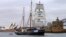 A supplied photo shows a tall ship displaying banners as it sails on Sydney Harbor in Australia, Sept. 8, 2018 as part of global climate change protests across 95 countries organized by the New York-based lobby group 350.org. 