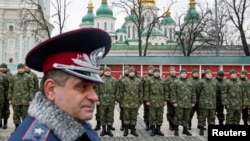 Members of the newly created Ukrainian interior ministry battalion "Saint Maria" take part in a ceremony before heading to military training, in front of St. Sophia Cathedral, in Kyiv, Feb. 3, 2015.