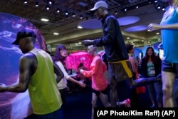 FILE: A woman feels the clothes on a display at Outdoor Retailer show, Salt Lake City, August 5, 2015. (AP Photo/Kim Raff)