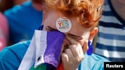 FILE - A same-sex marriage supporter reacts at Dublin Castle in Dublin, Ireland, May 23, 2015.