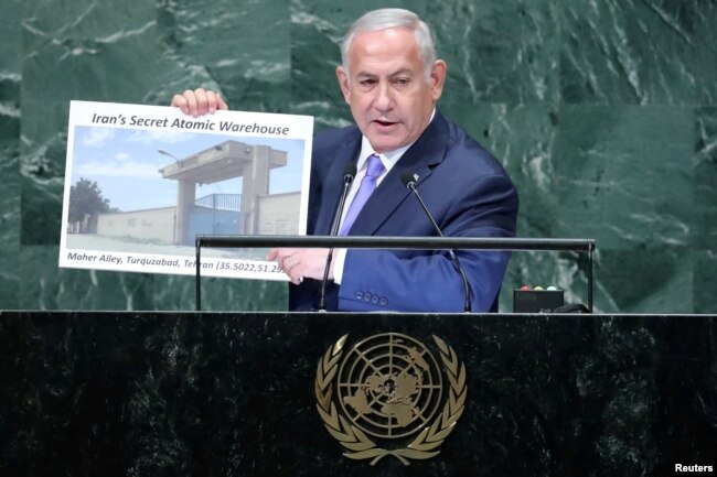 FILE - Israel’s Prime Minister Benjamin Netanyahu shows a photograph of a warehouse in Tehran during the 73rd session of the United Nations General Assembly, at U.N. headquarters, Sept. 27, 2018.