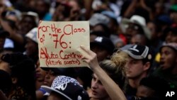 A student holds a placard during their protest against university tuition hikes outside the ruling party African National Congress (ANC) headquarters in Johannesburg, South Africa, Thursday, Oct. 22, 2015. 