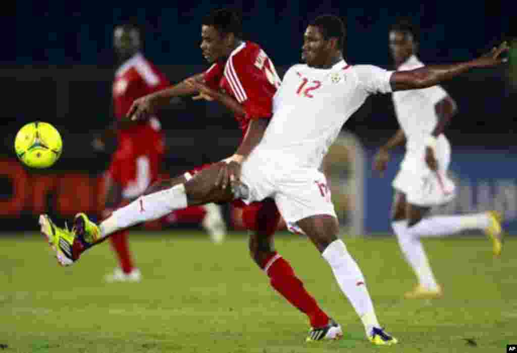 Prejuce Nakoulma of Burkina Faso (R) fights for the ball with Mohamed Ahmed of Sudan during their African Nations Cup Group B soccer match at Estadio de Bata "Bata Stadium", in Bata January 30, 2012.