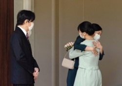Japan's Princess Mako hugs her sister Princess Kako and they are watched by her parents, Crown Prince Akishino and Crown Princess Kiko, before leaving her home for her marriage in Akasaka Estate in Tokyo, Japan October 26, 2021 in this photo taken by Kyod0.