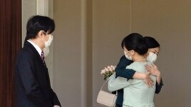Japan's Princess Mako hugs her sister Princess Kako and they are watched by her parents, Crown Prince Akishino and Crown Princess Kiko, before leaving her home for her marriage in Akasaka Estate in Tokyo, Japan October 26, 2021 in this photo taken by Kyod0.