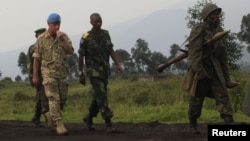 U.N. Deputy Force Commander in Congo, General Adrian Foster, left, of Britain, visits the area where M23 rebels fought with Congo government troops close to the eastern city of Goma, July 29, 2012.