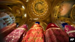 FILE - Russian Orthodox priests attend the Easter service in the Christ the Savior Cathedral in Moscow, Russia, Sunday, April 8, 2018. (AP Photo/Alexander Zemlianichenko, Pool)