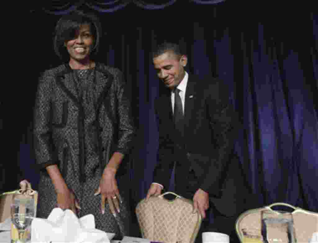 President Barack Obama pulls out a chair for first lady Michelle Obama as they arrive at the National Prayer Breakfast in Washington, Thursday, Feb. 3, 2011. (AP Photo/Charles Dharapak)