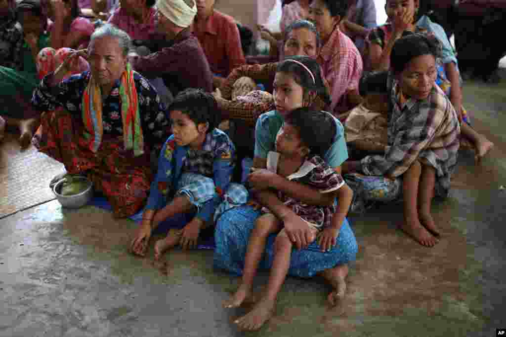 Villagers take shelter from flooding in Pwintbyu township, Minbu, Magway division, Aug. 2, 2015.