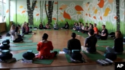 FILE - In this Oct. 1, 2014, file photo, students meditate during Mindful Studies class at Wilson High School in Portland, Oregon. (AP Photo/Gosia Wozniacka, File)