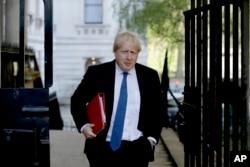 FILE - Britain's Foreign Secretary Boris Johnson arrives for a cabinet meeting at 10 Downing Street in London, Tuesday, May 1, 2018.
