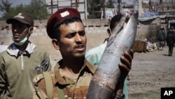 A defected army soldier shows an artillery shell allegedly fired by troops loyal to President Ali Abdullah Saleh in Sanaa, Yemen, October 27, 2011.