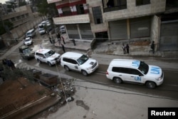 An aid convoy of Syrian Arab Red Crescent and UN drives through the rebel held besieged city of Douma towards the besieged town of Kafr Batna to deliver aid, on the outskirts of Damascus, Syria, Feb. 23, 2016.