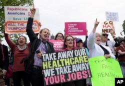 Protesters chant as Republican and Democratic House members walk down the steps of the Capitol in Washington, May 4, 2017, after the Republican health care bill passed in the House.