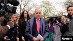 FILE - U.S. President Donald Trump's economic adviser Larry Kudlow is trailed by reporters after speaking at the White House in Washington, April 6, 2018. 
