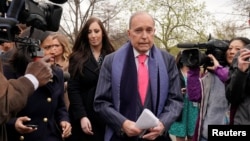 FILE - U.S. President Donald Trump's economic adviser Larry Kudlow is trailed by reporters after speaking at the White House in Washington, April 6, 2018. 