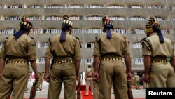 FILE - Indian policemen in ceremonial uniforms stand at attention in front of the civil secretariat complex on the first day of the Darbar Move in Srinagar, May 9, 2011. 