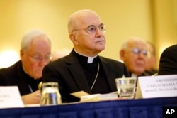 FILE - Archbishop Carlo Maria Vigano listens to remarks at the U.S. Conference of Catholic Bishops' annual fall meeting in Baltimore, Md., Nov. 16, 2015.