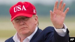 FILE - President Donald Trump waves as he steps off Air Force One after arriving, June 7, 2019, at Andrews Air Force Base, Md. 