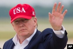 FILE - President Donald Trump waves as he steps off Air Force One after arriving at Andrews Air Force Base, Md., June 7, 2019.