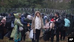 Migrants from the Middle East and elsewhere gather at the Belarus-Poland border near Grodno, Belarus, Monday, Nov. 8, 2021. 