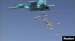 FILE - A still image, taken from video footage and released by Russia's Defense Ministry on Aug. 18, 2016, shows a Russian Sukhoi Su-34 fighter-bomber based at Iran's Hamadan air base, dropping bombs in the Syrian province of Deir ez-Zor.