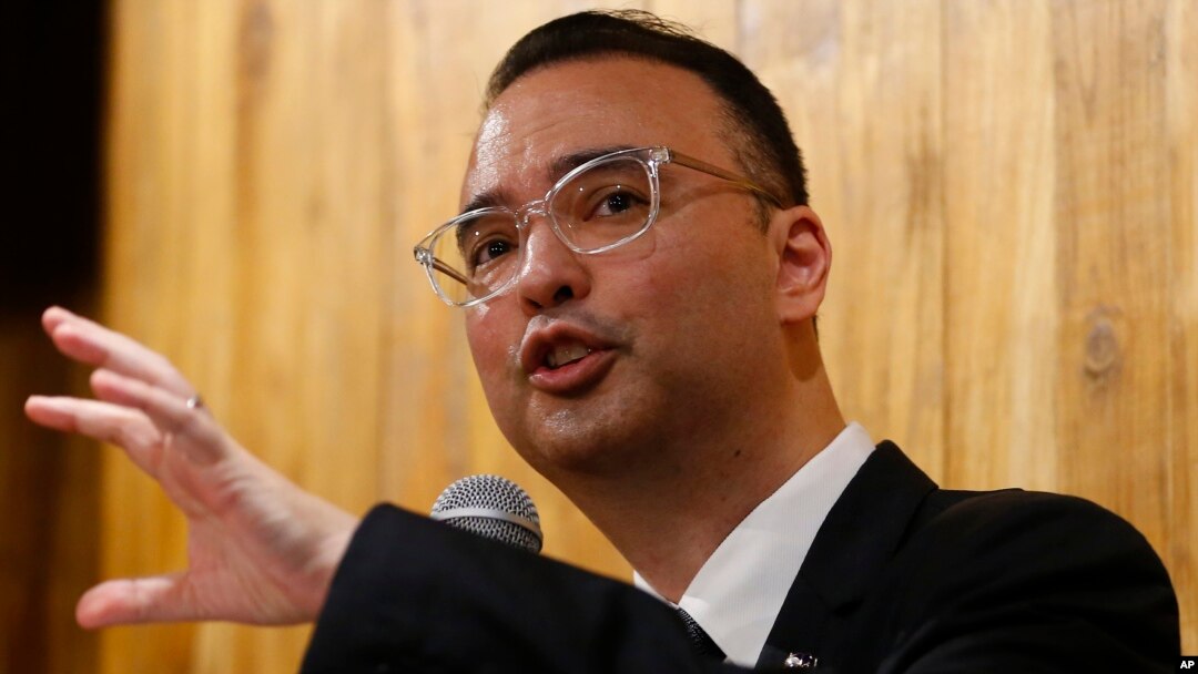 Philippine Foreign Affairs Secretary Alan Peter Cayetano gestures during a news conference on the South China Sea on Tuesday, Aug. 7, 2018, in suburban Taguig city east of Manila, Philippines. (AP Photo/Bullit Marquez)